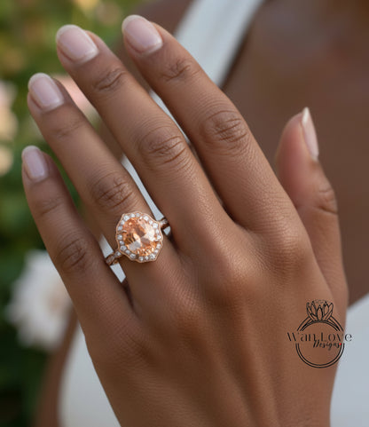 A close-up of a person's hand wearing a large, oval-shaped engagement ring with a halo of smaller diamonds around the center stone.
