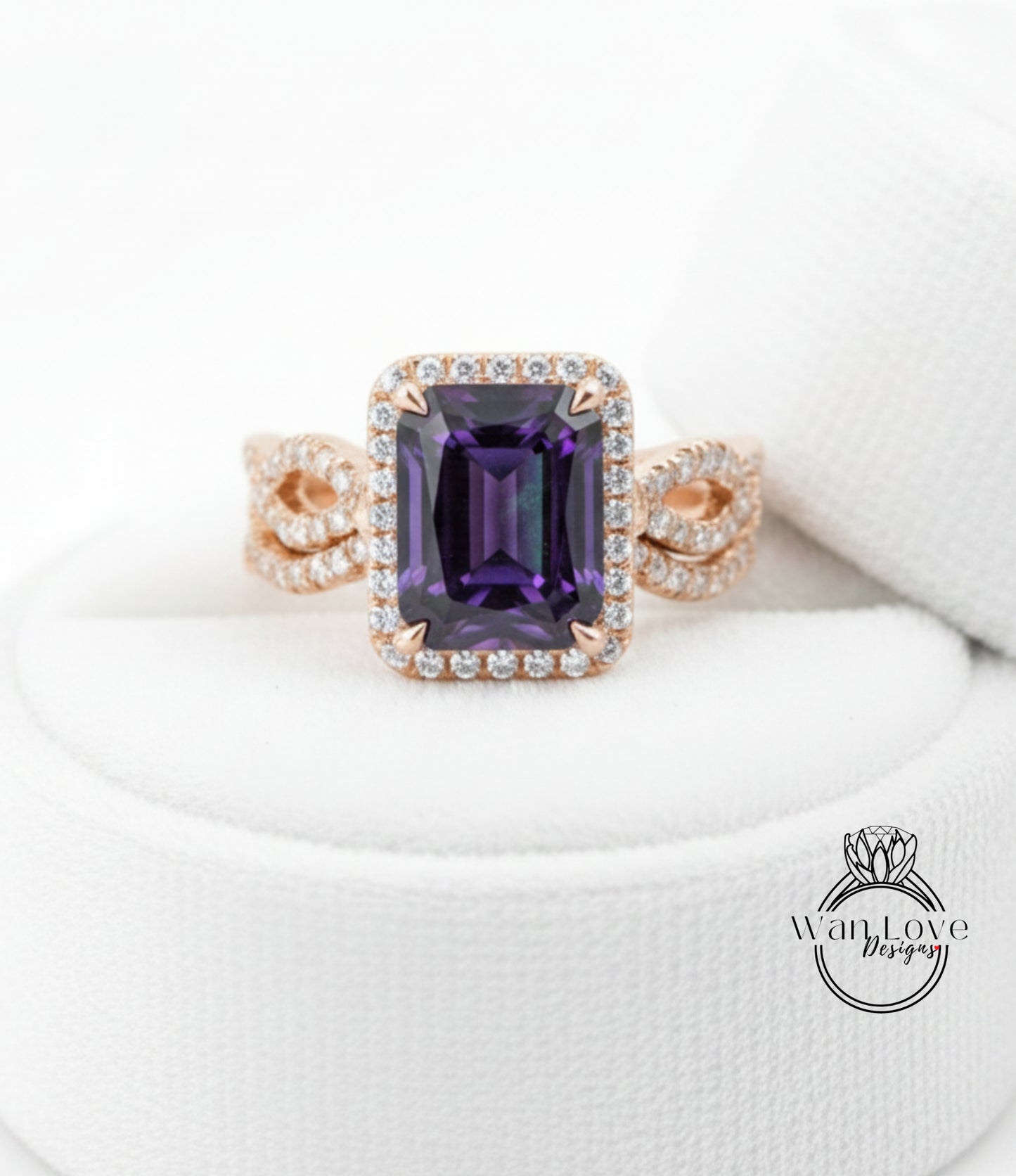 A gold ring with a large purple gemstone, likely an amethyst, set in a halo of smaller diamonds.