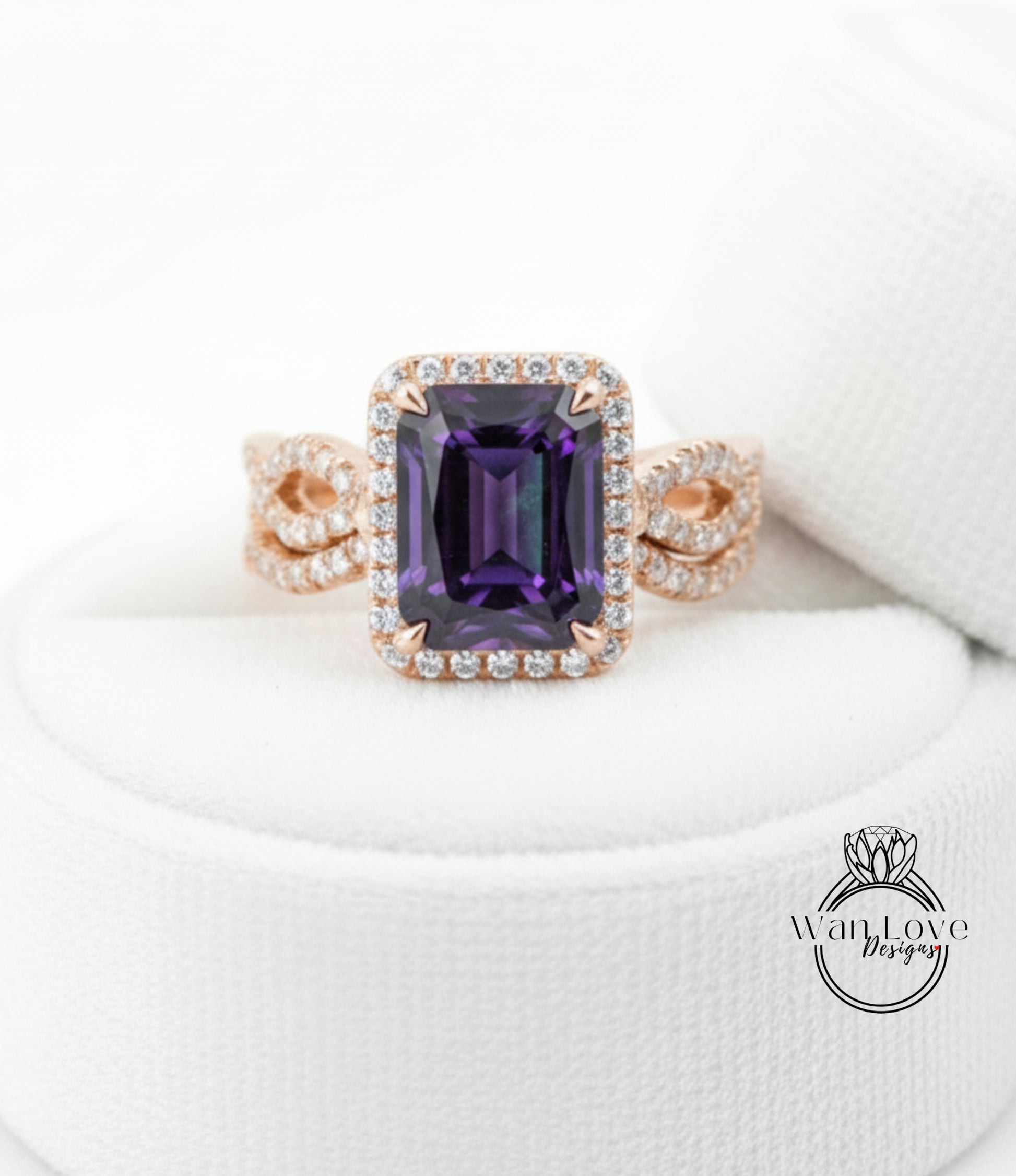 A gold ring with a large purple gemstone, likely an amethyst, set in a halo of smaller diamonds.