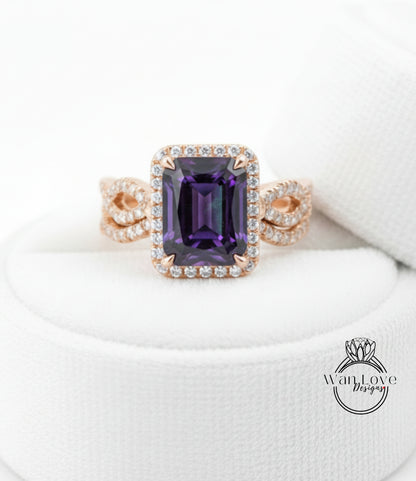 A gold ring with a large purple gemstone, likely an amethyst, set in a halo of smaller diamonds.