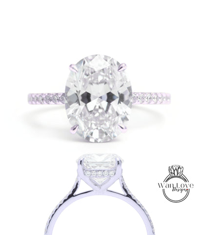 A large oval-shaped diamond engagement ring with a halo of smaller diamonds around the center stone.