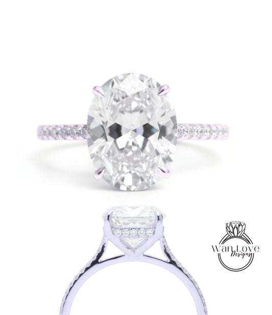 A large oval-shaped diamond engagement ring with a halo of smaller diamonds around the center stone.
