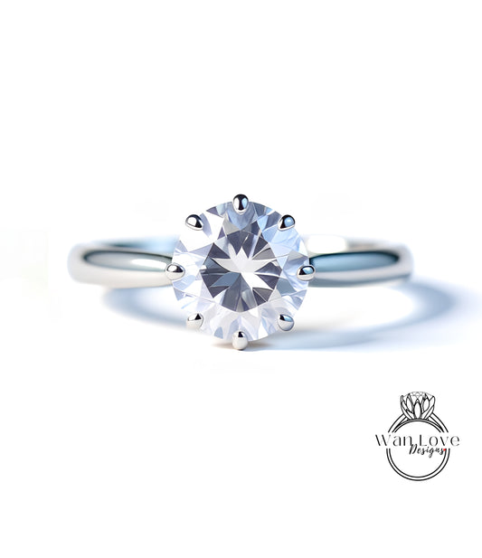 A close-up of a diamond engagement ring with a large, clear gemstone set in a silver band.