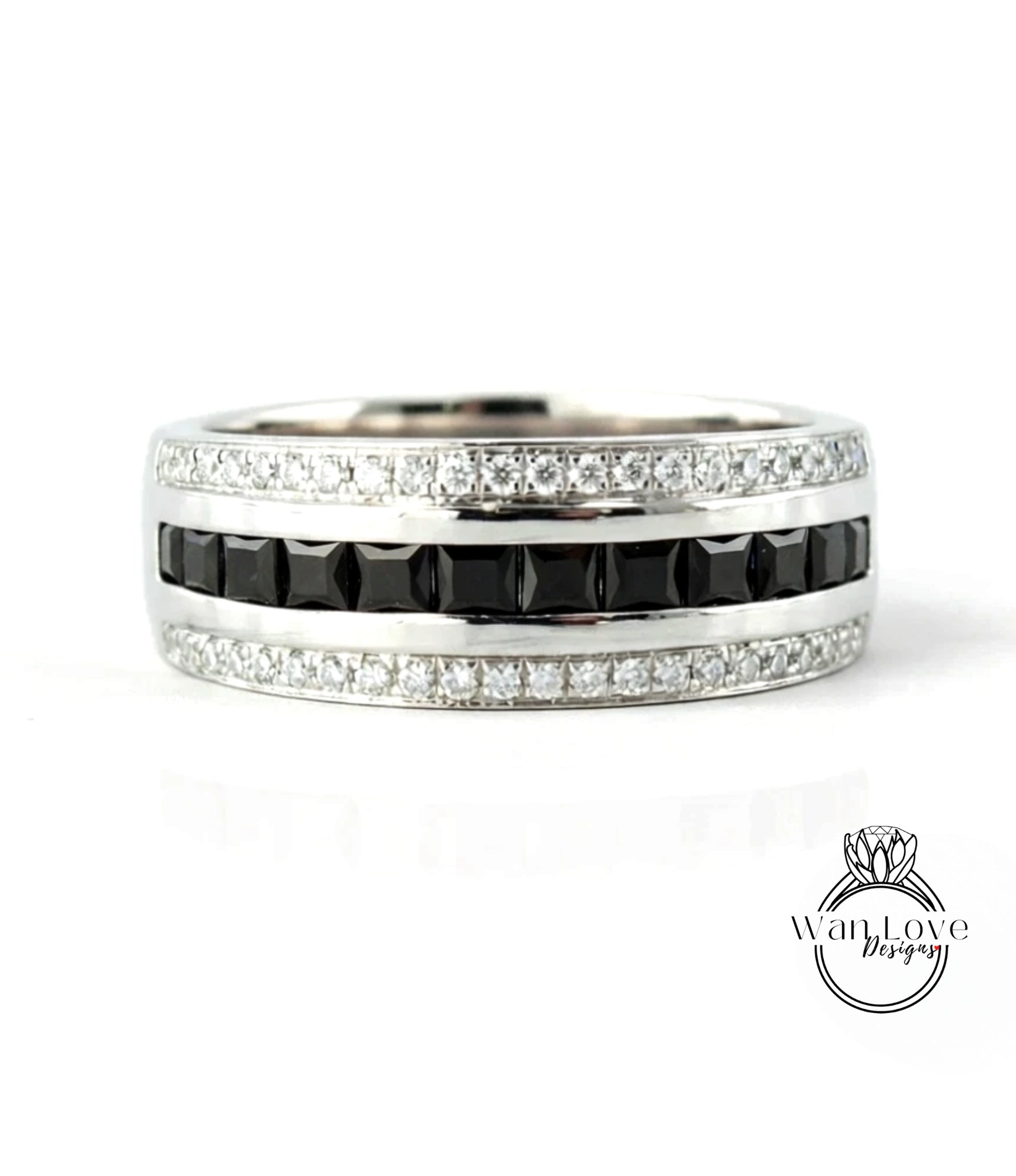 A silver ring with a row of black diamonds and a row of white diamonds along the band.