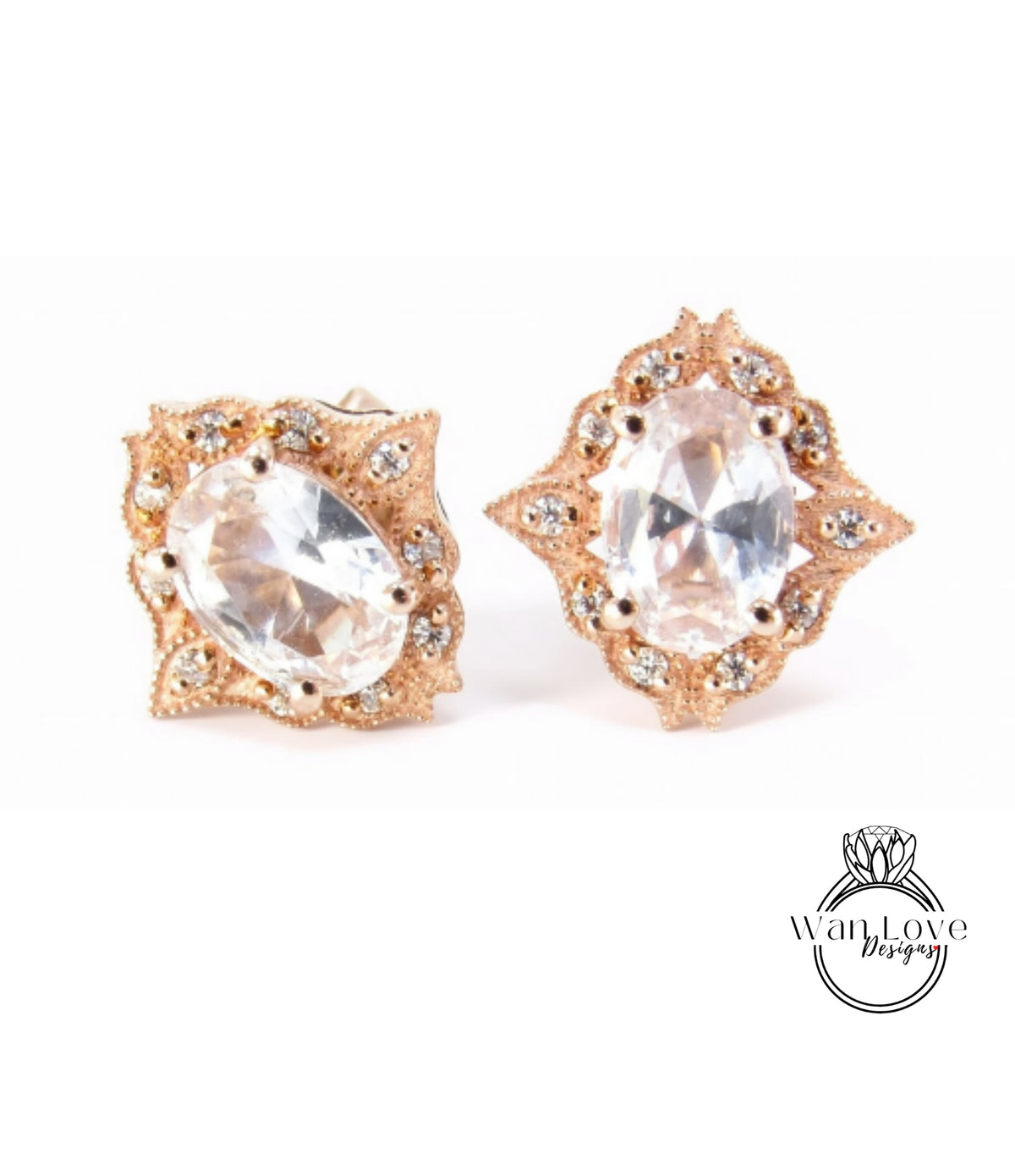 two ornate earrings with large, clear gemstones set in a decorative gold frame.