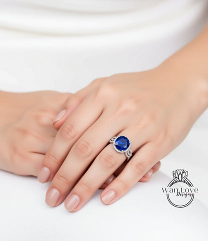 A close-up of a person's hand wearing a ring with a large blue gemstone.