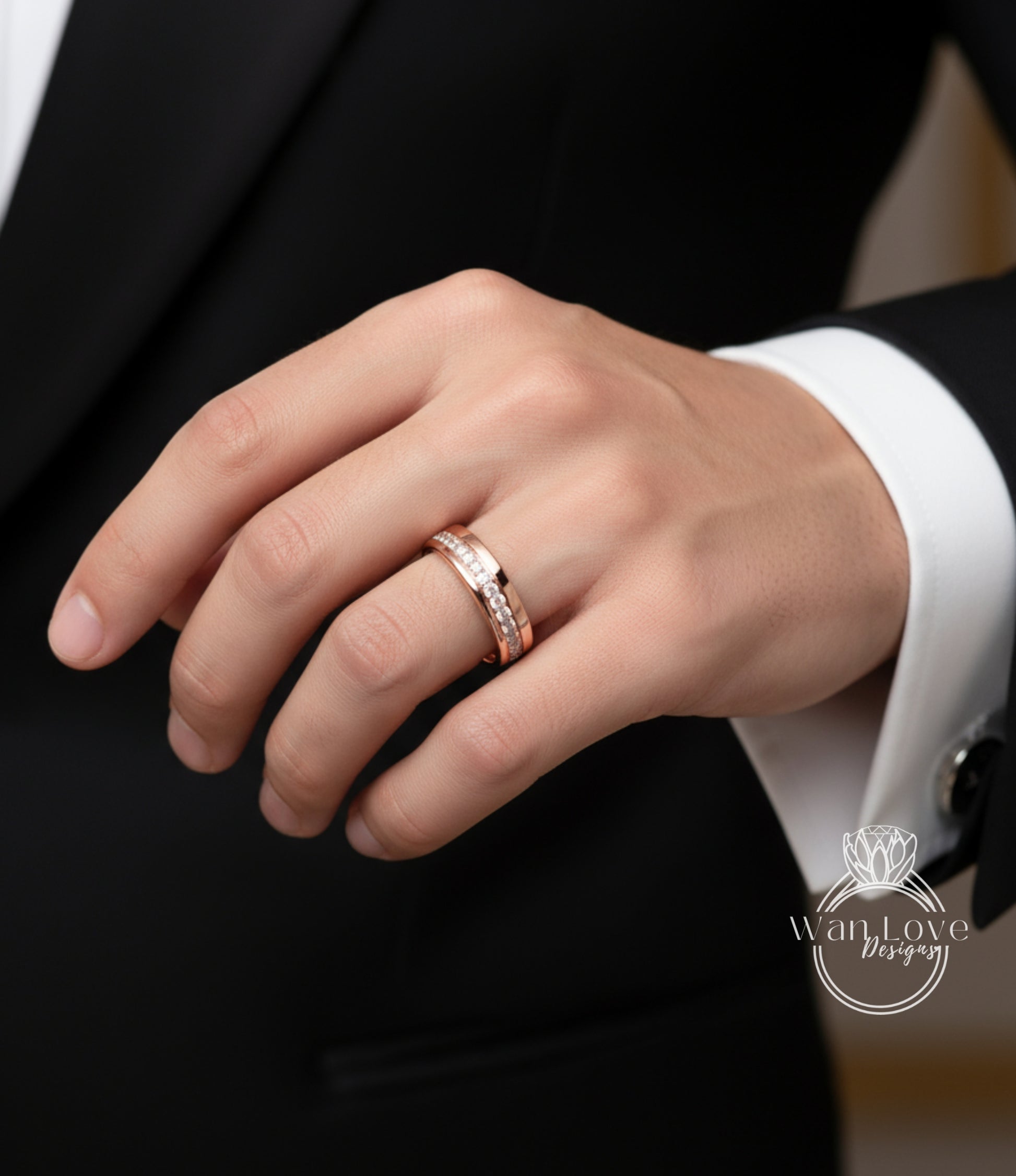 A close-up of a person's hand wearing a gold ring on the ring finger.