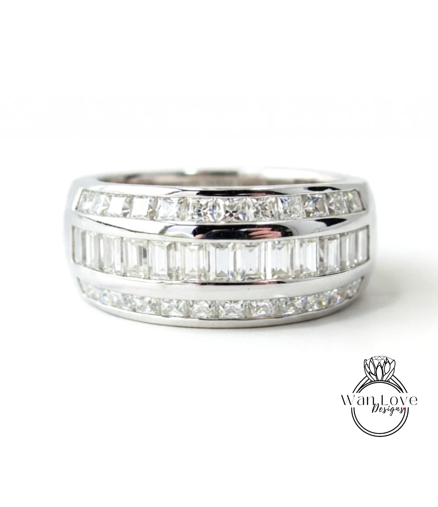 A silver ring with a row of diamonds set in it.