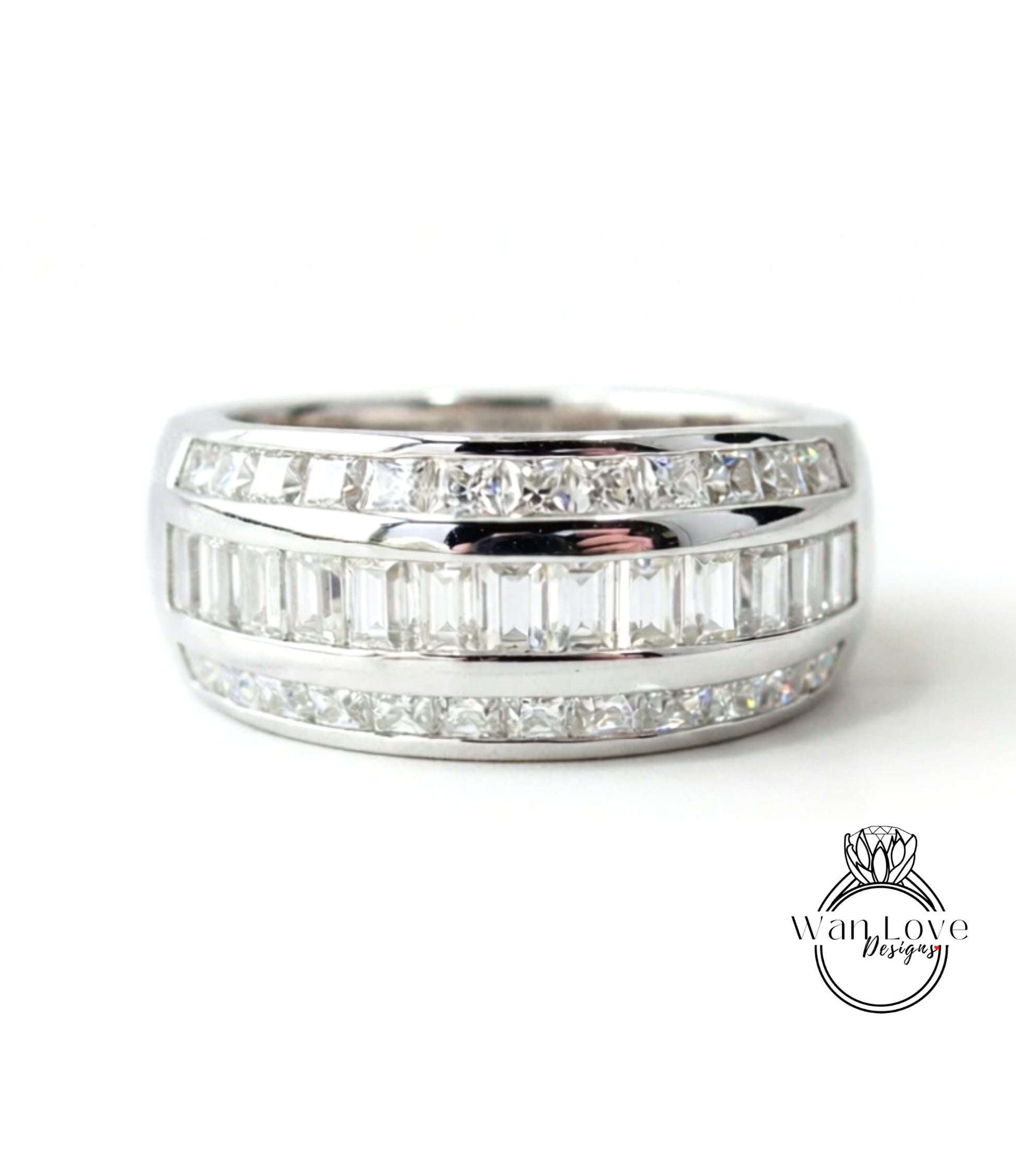 A silver ring with a row of diamonds set in it.