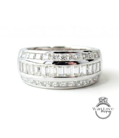 A silver ring with a row of diamonds set in it.