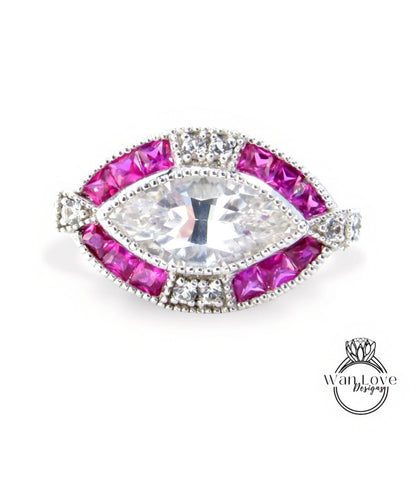 A ring with a large, clear gemstone surrounded by smaller, pink gemstones.