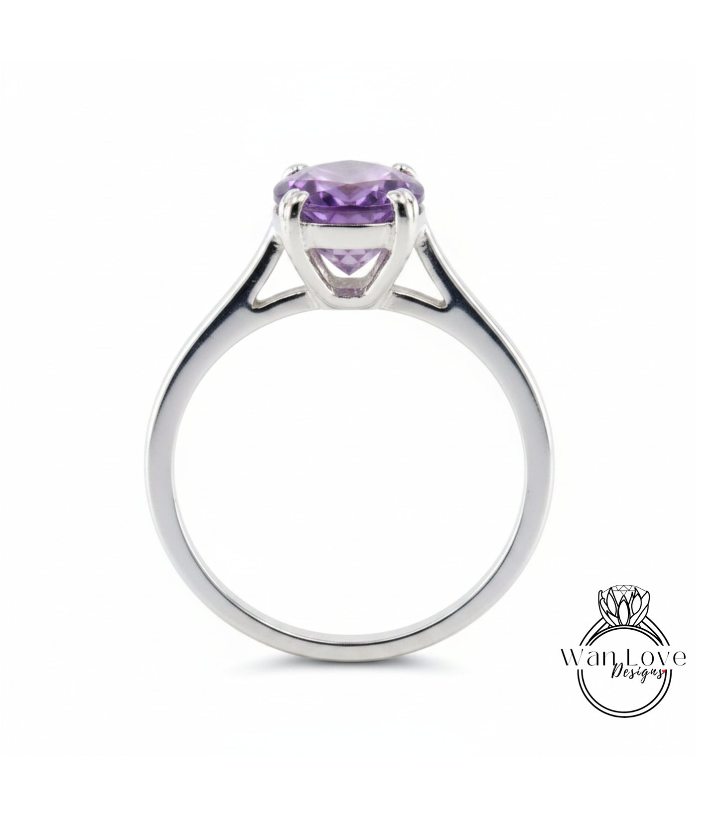 A silver ring with a large, purple gemstone set in the center.