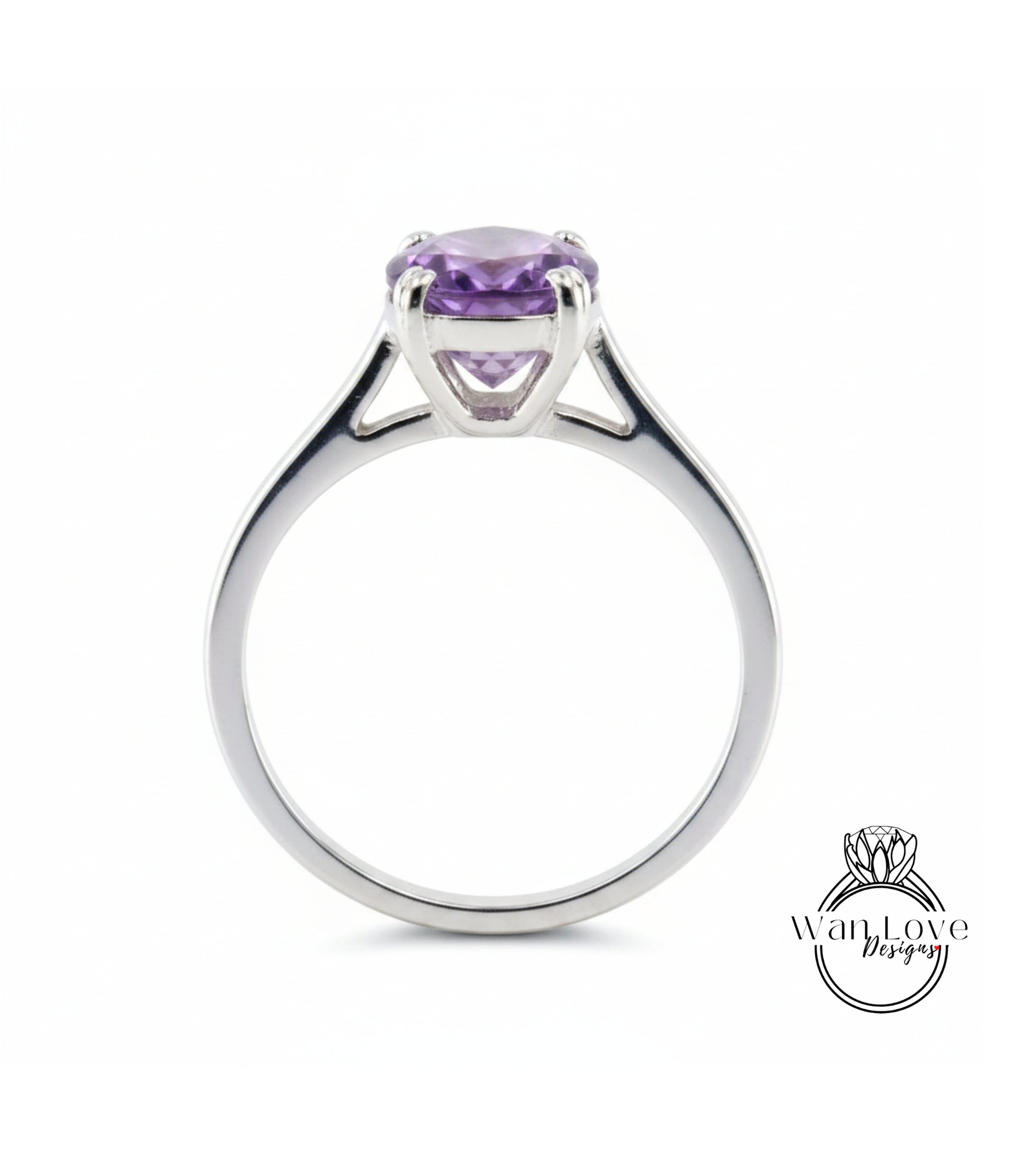 A silver ring with a large, purple gemstone set in the center.