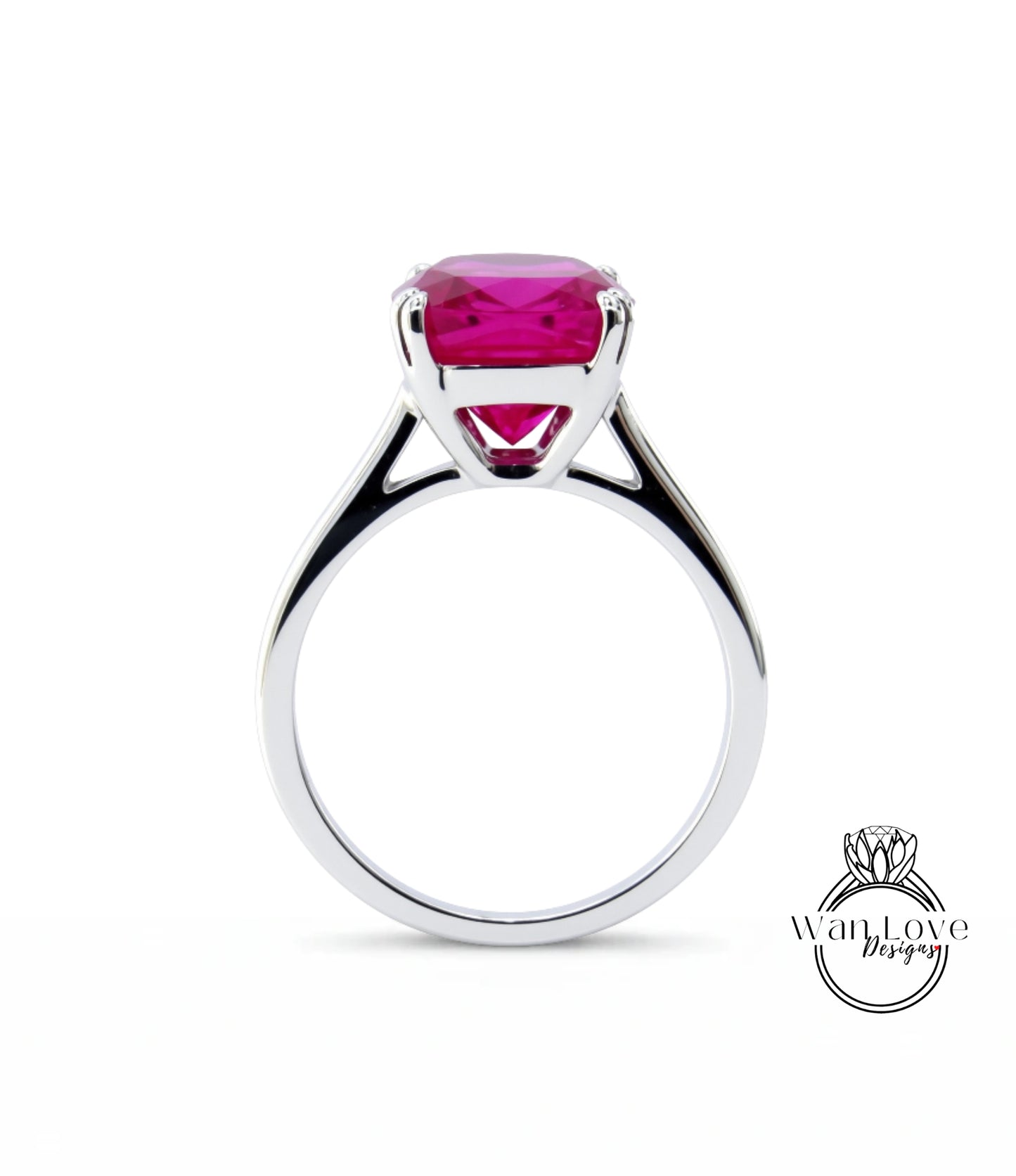 A silver ring with a large, bright pink gemstone set in the center.