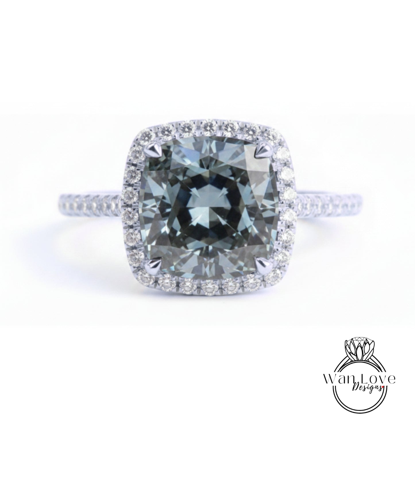 A large, square-cut diamond ring with a halo of smaller diamonds around the center stone.