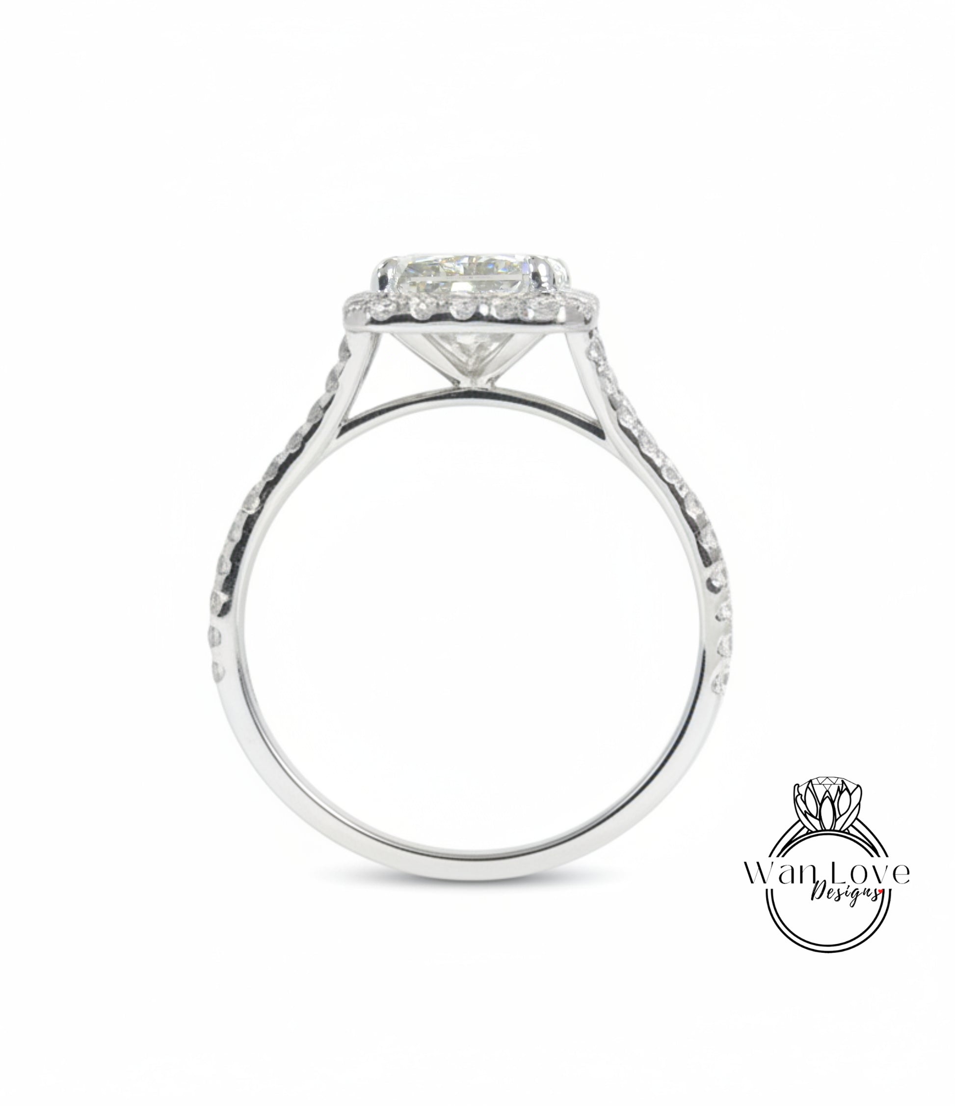 A silver engagement ring with a large central diamond and a halo of smaller diamonds around the center stone.