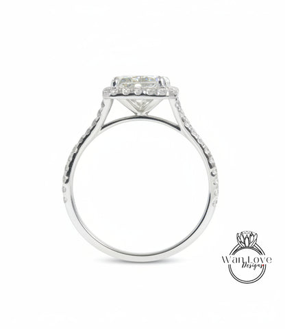 A silver engagement ring with a large central diamond and a halo of smaller diamonds around the center stone.
