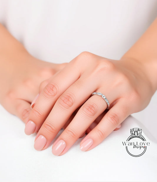A close-up image of a person's hands wearing a ring on the ring finger.