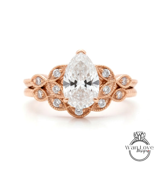 a beautiful engagement ring with a large central diamond surrounded by smaller diamonds on either side, set in a rose gold band.
