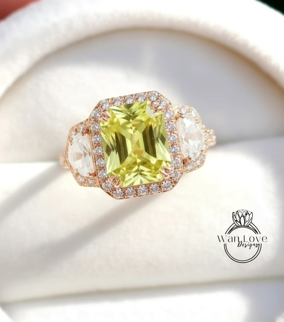 A close-up image of a gold ring with a large, vibrant green gemstone set in a halo of smaller diamonds.