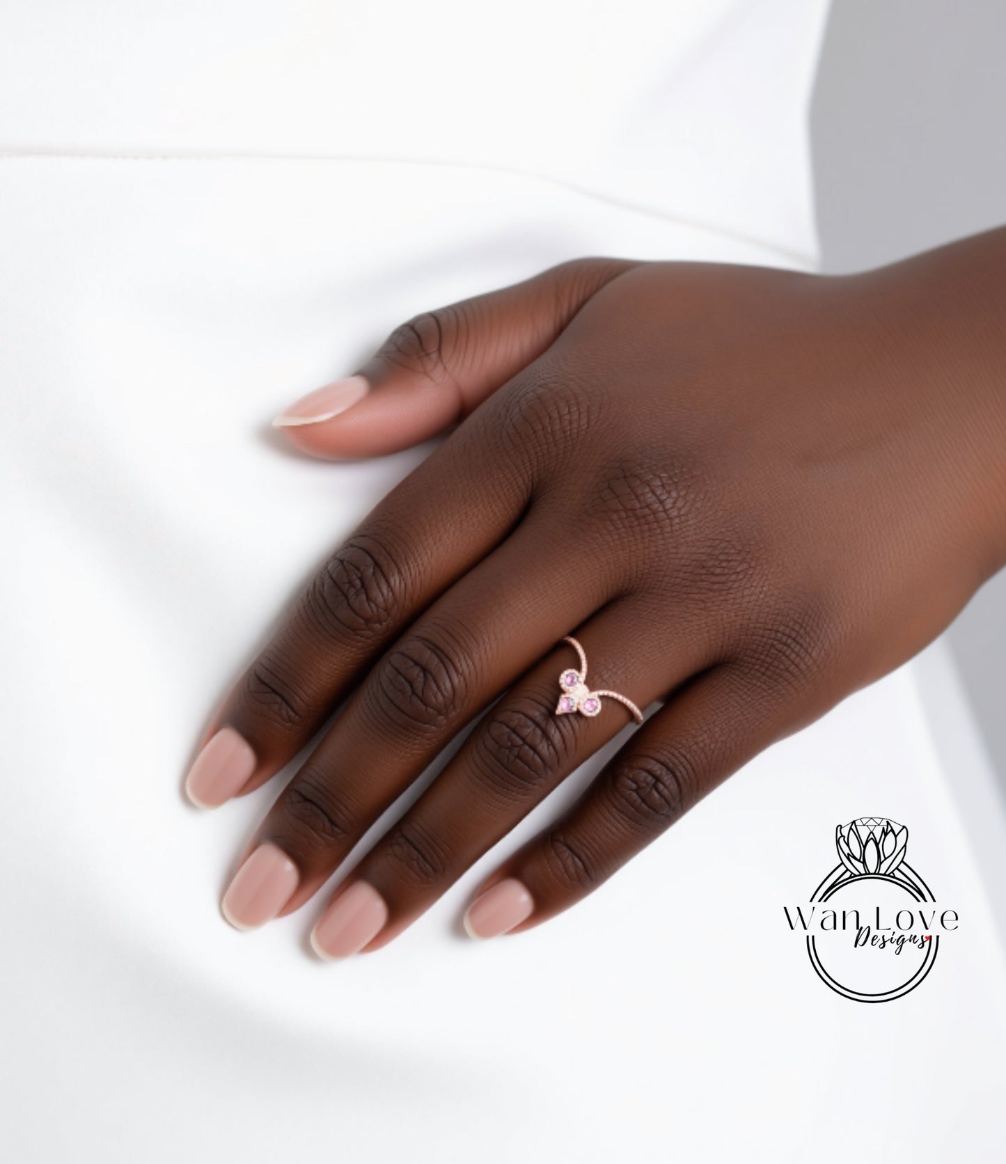 A close-up of a hand wearing a ring with a heart-shaped gemstone.