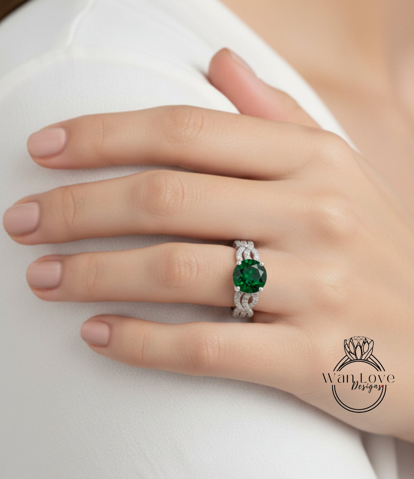 A close-up of a person's hand wearing a ring with a large green gemstone.
