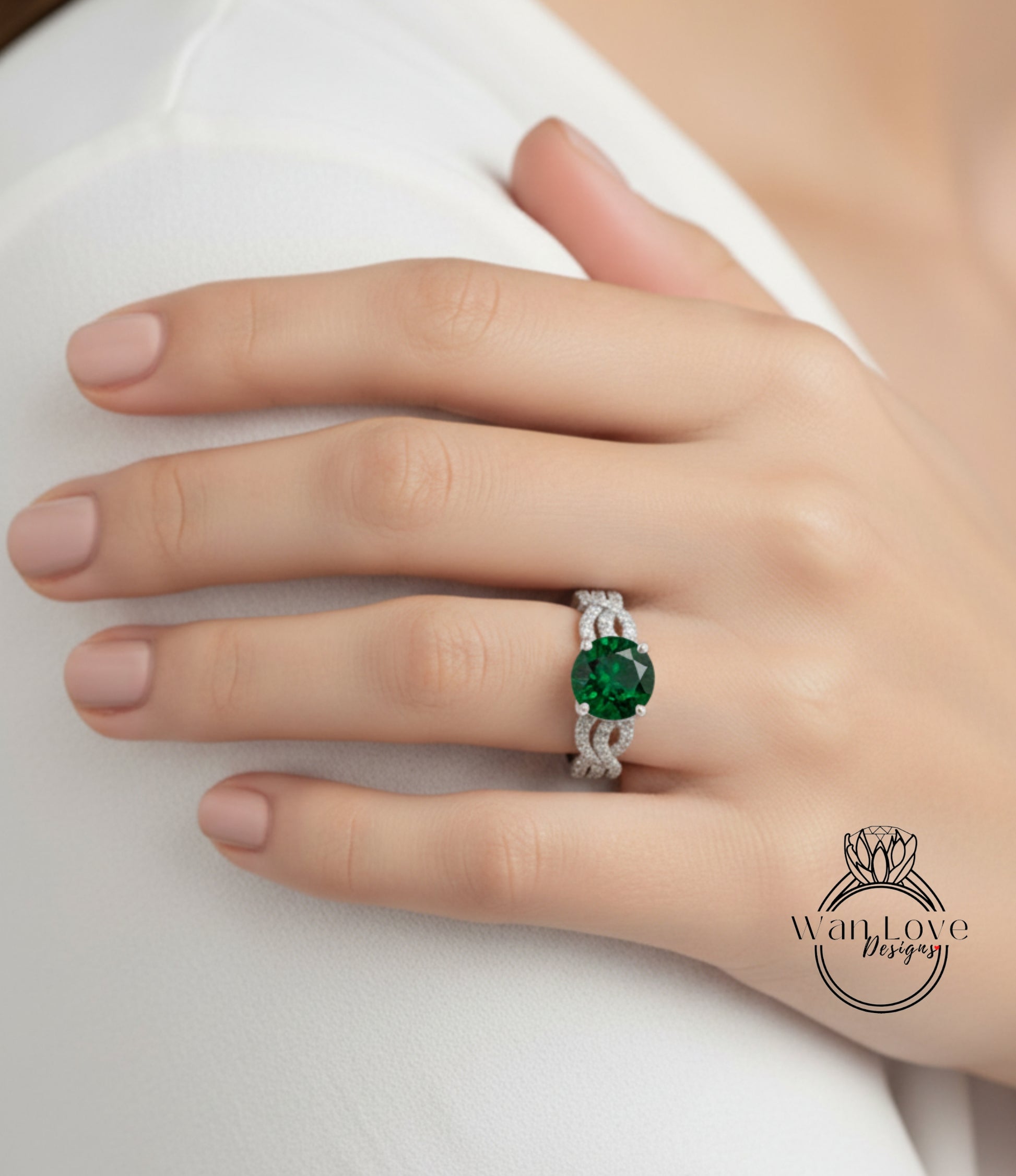A close-up of a person's hand wearing a ring with a large green gemstone.