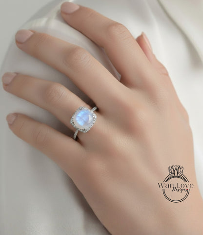A close-up of a hand wearing a ring with a large, round, and bright blue gemstone.