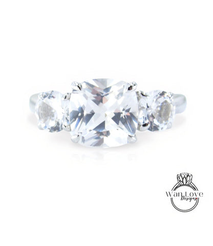 A close-up view of a diamond engagement ring with a large, clear gemstone set in a silver band.