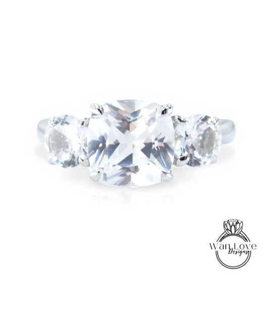 A close-up view of a diamond engagement ring with a large, clear gemstone set in a silver band.