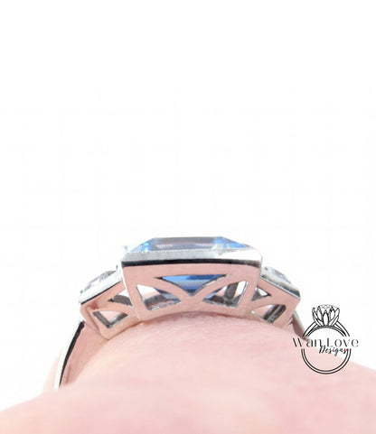 A close-up view of a silver ring with a large blue gemstone, showcasing the intricate design and craftsmanship of the piece.