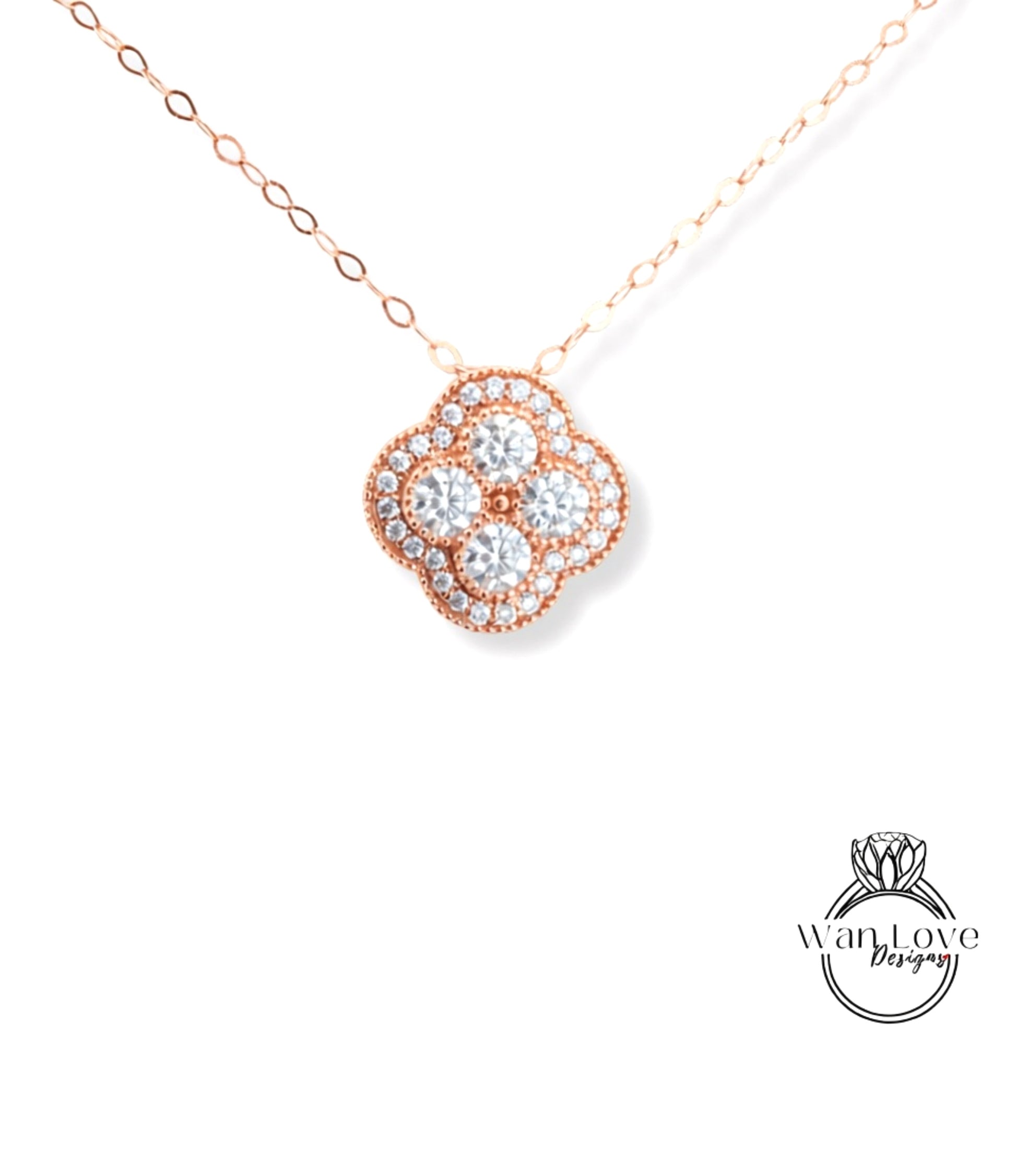 A delicate necklace with a pendant featuring a cluster of small, clear diamonds set in a rose gold-colored metal.