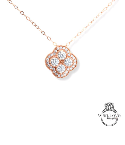 A delicate necklace with a pendant featuring a cluster of small, clear diamonds set in a rose gold-colored metal.