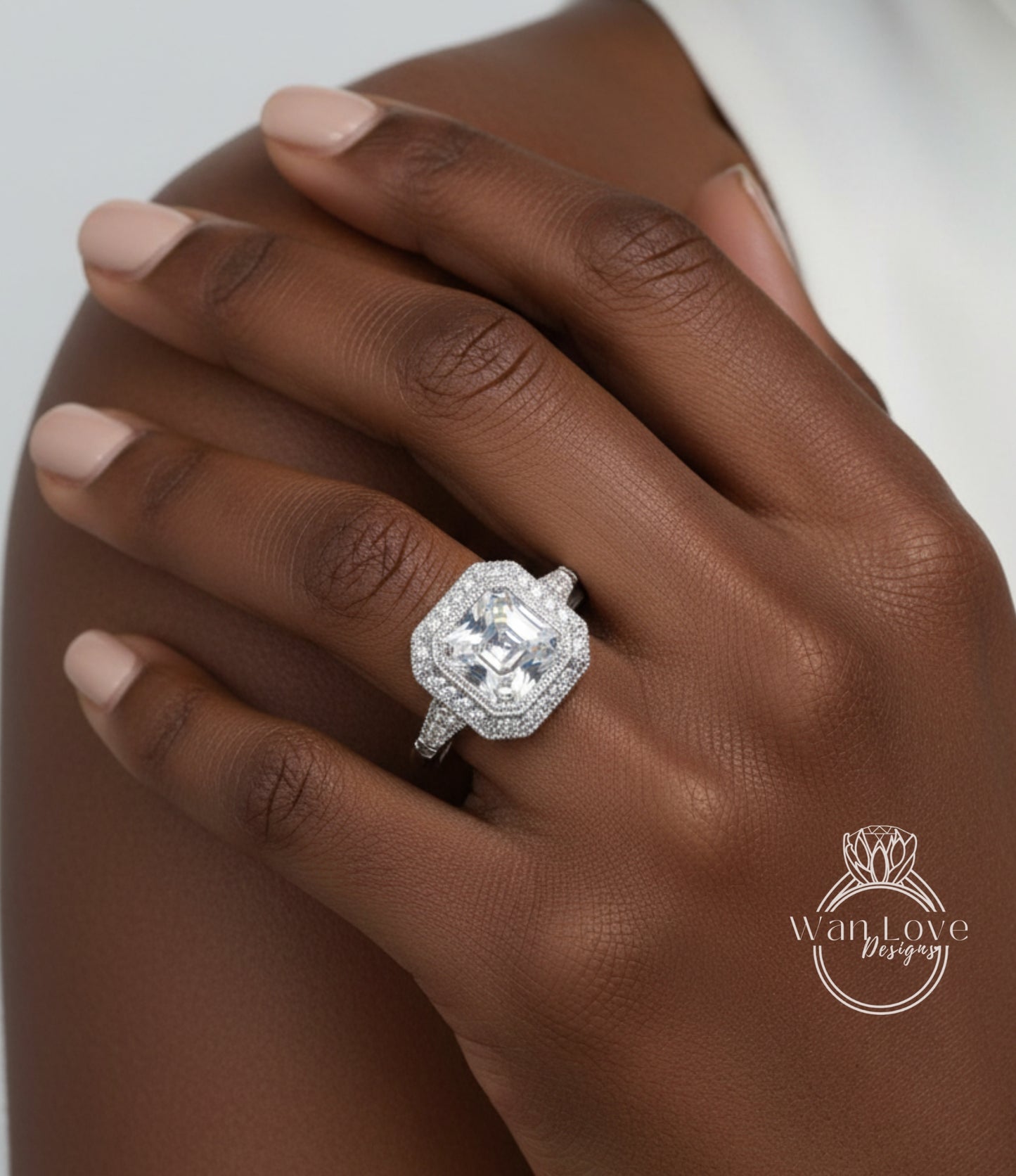 A close-up of a person's hand wearing a large, sparkling diamond ring.