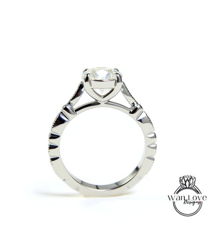 A close-up view of a silver engagement ring with a large central diamond and intricate metalwork detailing.