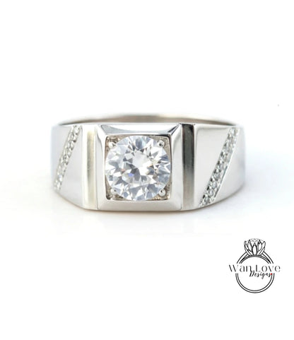 A silver ring with a large, clear gemstone set in the center.