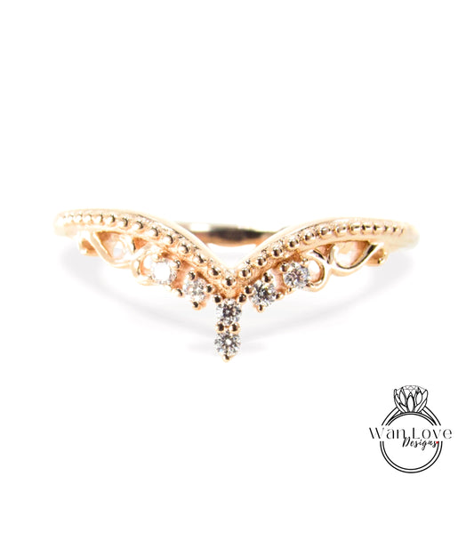 A gold ring with a decorative band featuring small diamonds.