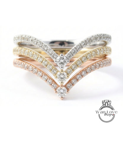 A ring with a diamond band and multiple diamond-encrusted bands, showcasing a variety of colors and designs.
