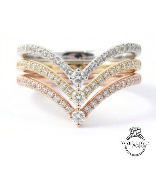 A ring with a diamond band and multiple diamond-encrusted bands, showcasing a variety of colors and designs.