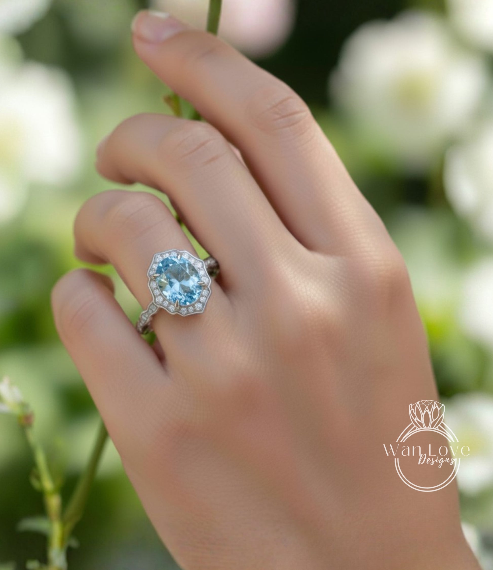 A close-up of a hand wearing a diamond ring with a blue gemstone.