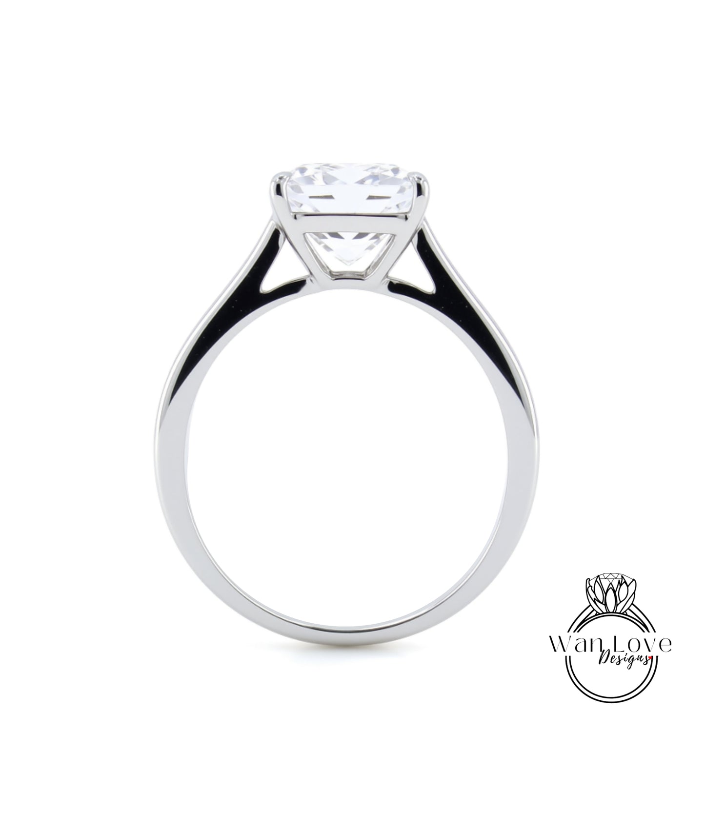 A silver engagement ring with a large, clear gemstone set in the center of the band.