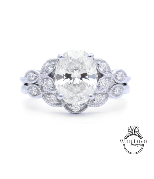 A close-up of a diamond engagement ring with a large oval-shaped diamond surrounded by smaller diamonds and a floral-inspired design.
