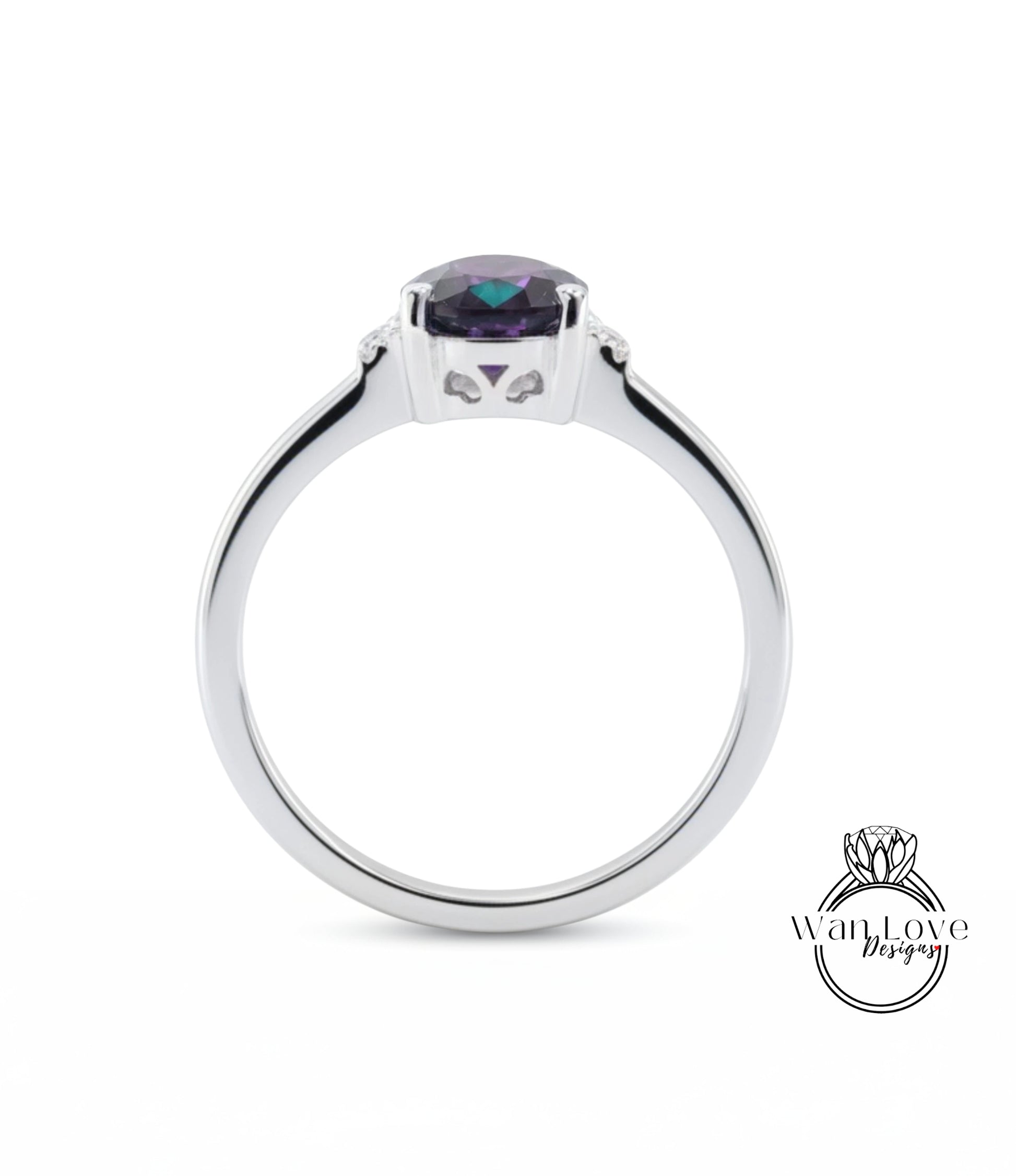 A silver ring with a large purple gemstone set in the center.