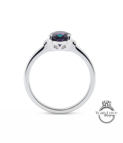 A silver ring with a large purple gemstone set in the center.