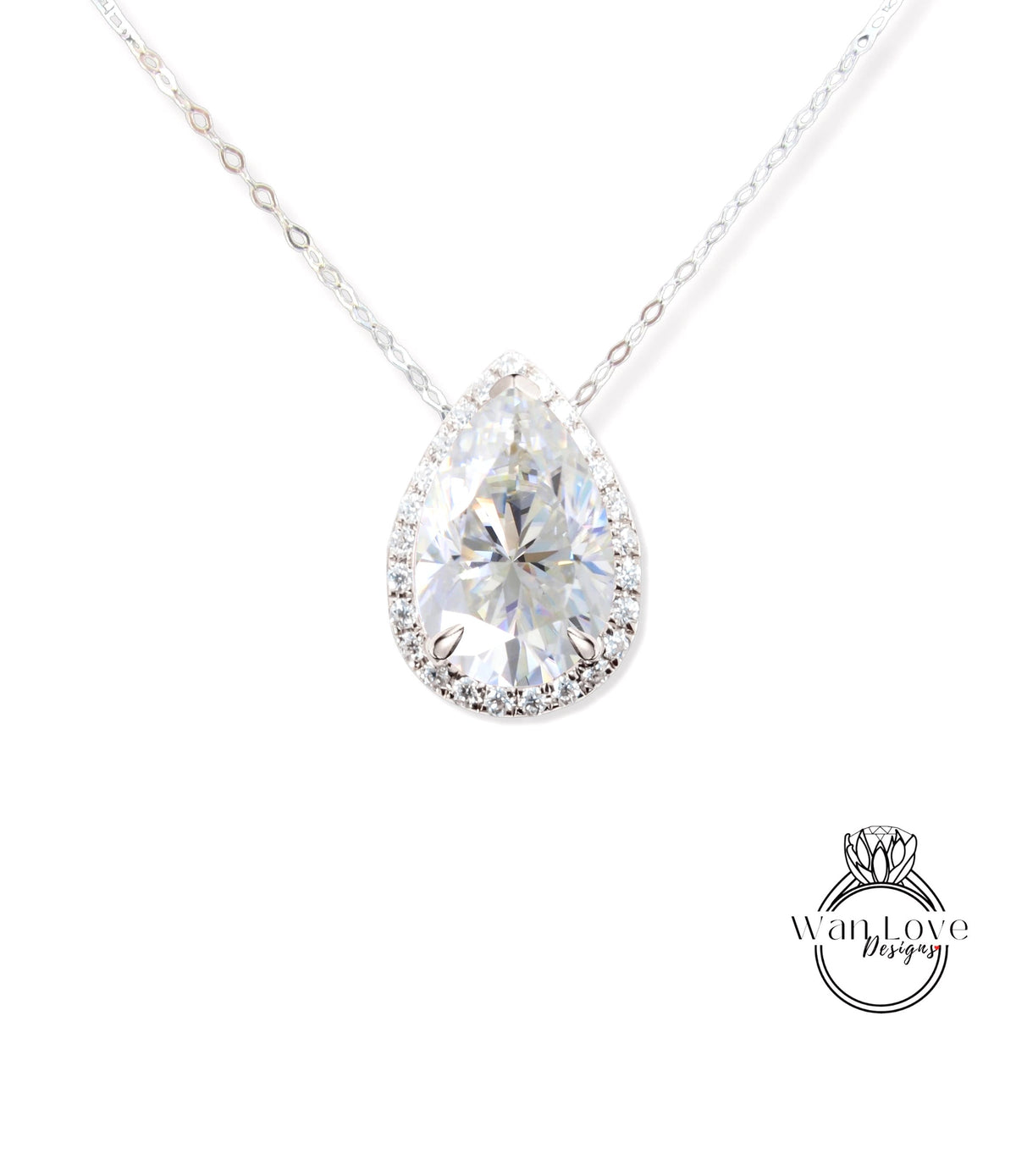 A close-up view of a diamond pendant necklace with a large, clear pear-shaped diamond set in a halo of smaller diamonds.