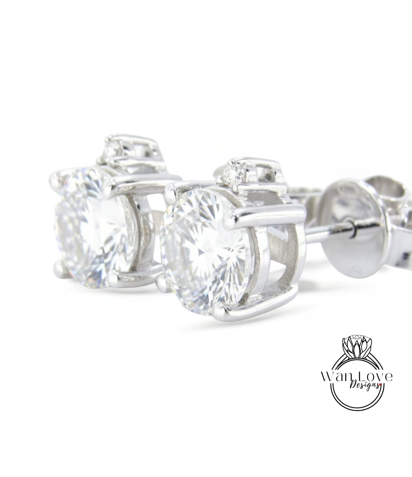 A pair of elegant silver earrings with large, clear gemstones set in a decorative metal frame.