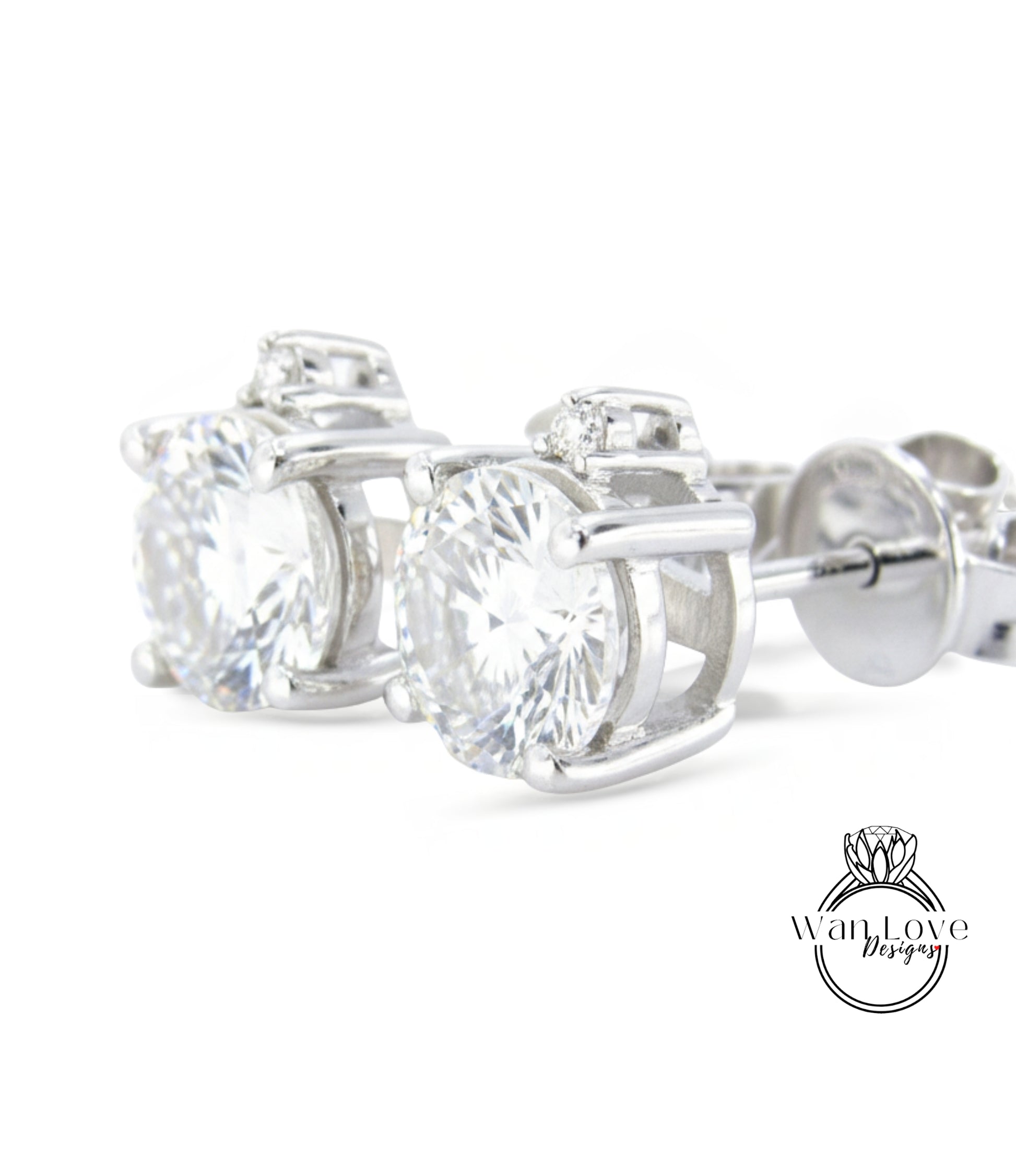 A pair of elegant silver earrings with large, clear gemstones set in a decorative metal frame.