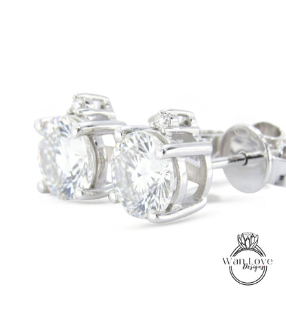 A pair of elegant silver earrings with large, clear gemstones set in a decorative metal frame.