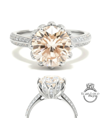 A large, round, light brown diamond engagement ring with a silver band and sparkling diamonds.