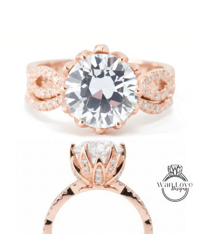 a beautiful rose gold ring with a large, clear gemstone set in the center. The ring has a delicate, intricate design with a floral motif and a prominent, sparkling gemstone.